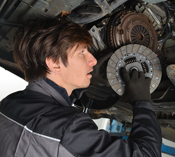 Repairman fixing transmission